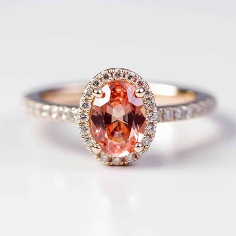 Sapphire Engagement Ring with Oval Padparadscha Experience the enchanting beauty of our Christina Padparadscha Engagement Ring, a true masterpiece in luxurious 18K gold. Meticulously designed by Brilliyond and handcrafted in Australia, this ring features a natural certified oval-shaped Padparadscha sapphire as the mesmerizing centre stone. Adorned with a dazzling halo of brilliant cut diamonds and additional diamonds along the band, this halo design exudes elegance and sophistication. Customize Padparadscha Ring Engagement, Padparadscha Sapphire Ring Engagement, Padparadscha Engagement Ring, Padparadscha Sapphire Engagement Ring, Padparadscha Sapphire Ring, Wooden Engagement Ring Boxes, Sapphire Engagement Ring Halo, Peach Sapphire Rings, Wooden Rings Engagement