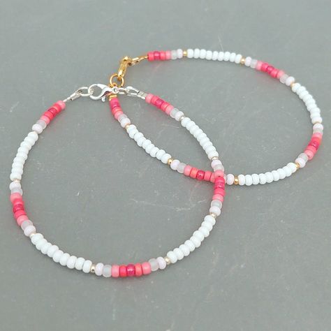 This pink summer seed bead bracelet has been lovingly made using good quality colourful 3mm glass Miyuki and Preciosa seed beads in pinks and white. Available with either 2mm silver or gold Miyuki seed beads to highlight. Threaded on strong stainless steel 7 strand Tiger Tail wire and finished with silver / gold plated wire guardians, a trigger clasp and optional extender chain. Matching necklace available on request. Matching Anklet available on request. More colours and designs can be found at: https://www.etsy.com/uk/shop/CraftHutCornwall BRACELET LENGTHS 6 1/2" Small 7"       Ladies - Small 7 1/2" Ladies - Standard (this is the most common size and generally the size most bracelets are made) 8"       Ladies - Standard Large / Mens - Standard 8 1/2" Ladies - Large / Mens - Standard Larg Cute Handmade Bracelets Beads, Bracelet Ideas With Small Beads, Seed Bead Bracelets For Men, Matching Seed Bead Bracelets, 3mm Bead Bracelet, Seed Bead Inspiration, Bracelet Beads Design, Bracelet Ideas Small Beads, Seed Beads Bracelets Ideas