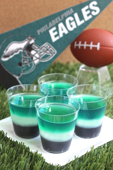 Philadelphia Eagles Jell-O Shots (3 1/2 Tbs grape Jell-O powder 2 3-oz boxes lime Jell-O 3 envelopes Knox plain gelatin  3 cup vodka  Black food coloring 1 cup milk 1/4 cup granulated sugar) Philadelphia Eagles Food Ideas, Philadelphia Eagles Desserts, Eagles Football Party, Philadelphia Eagles Cake, Eagles Party, Superbowl Party Food Ideas, Jell O Shots, Superbowl Sunday, Pudding Shots