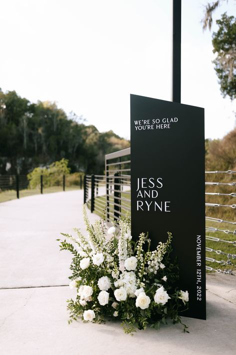 We're so glad youre here! Sign: Andi & Mejia Photographer: Tiffany Maysonet Wedding Welcome Flowers, Glad Youre Here Sign, Black Welcome Sign Wedding, Pretzel Food Truck, Welcome Signs For Wedding, Outdoor Wedding Aisle Decor, Signage Flowers, Hanging Floral Chandelier, Welcome Sign Decor