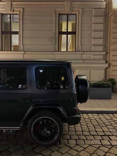 A black mercedes g wagon in front of the Ritz-Carlton in Vienna Austria Black G Wagon Aesthetic, Aesthetic G Wagon, Mercedes G Wagon Aesthetic, G Wagon Black, G Wagon Aesthetic, World Expensive Car, Expensive Aesthetic, Black G Wagon, Expensive Life