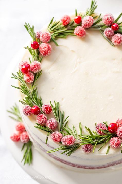 A red velvet layer cake with a wreath made of rosemary sprigs and sugared cranberries. Cake With Rosemary Decoration, Best Cream Cheese Icing, Christmas Red Velvet Cake, Red Velvet Christmas Cake, Best Red Velvet Cake, Pear And Almond Cake, Cake 3d, Cranberry Cake, Best Christmas Desserts