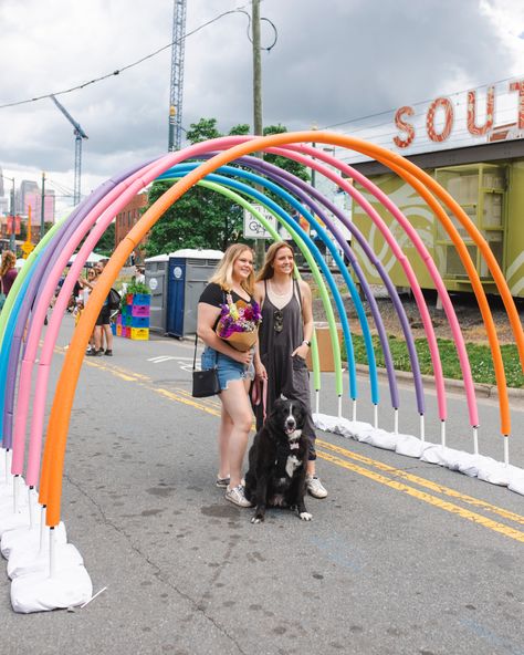 Row of pool noodle arches to look like a rainbow Pool Noodle Installation, Pride Art Installation, Photo Op Ideas Events, Diy Outdoor Stage, Pool Noodle Backdrop, Pride Event Decor, Festival Event Ideas, Pride Event Ideas, Pride Installation