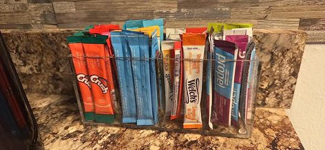 Water Packet Storage Ideas, Organizing Water Flavor Packets, How To Organize Water Flavor Packets, Drink Mix Storage Ideas, Powder Drink Mix Storage, Flavored Water Packets Storage, Water Packet Organization, Drink Mix Packet Storage, Drink Packet Storage