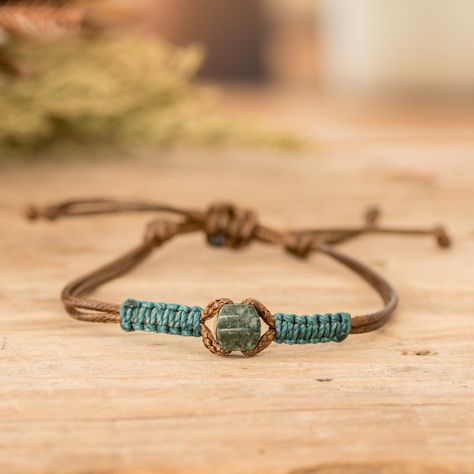 The star of the show in this fashionable men's bracelet is a captivating dark green jade pendant that takes center stage with its exotic allure. Expertly accented with intricate waxed cotton macrame detailing in a vibrant teal hue, Guatemalan artisans Erick and Ivania's impressive design seamlessly fuses tradition and contemporary flair. Its adjustable brown nylon cord ensures a tailored fit, allowing you to wear this accessory with ease and comfort. Chinese Cord Bracelets, Corded Bracelets Diy, Diy Jewelry For Men, Bracelets With Embroidery Thread, Macrame Bracelet Patterns Easy, Macrame For Men, Diy Macrame Bracelet Tutorial, Easy Bracelet Patterns, Handmade Bracelets For Men