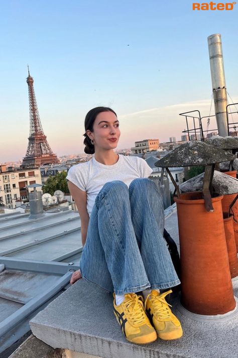 A girl sitting on a rooftop in Paris with the Eiffel Tower in the background wearing Onitsuka Tiger Mexico 66 Yellow Black Trainers Retro Sneakers Aesthetic, Onitsuka Tiger Tokuten Women Outfit, Yellow Shoes Outfit Black Women, Onitsuka Tiger Street Style, Yellow Tiger Shoes Outfit, Styling Yellow Shoes, Yellow Mexico 66 Outfit, Yellow Tiger Shoes, Onitsuka Tiger Yellow Women Outfit