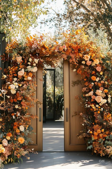 Outdoor fall wedding setup with doors adorned in vibrant autumn floral arrangements, showcasing autumn elegance and rustic wedding aisle decorations. Terracotta Wedding Ideas, Sunset Terracotta Wedding Colors, Wedding Autumn Decoration, Terracotta Flowers Wedding, Warm Earth Tone Wedding, Terracotta Reception, Orange And Brown Wedding, Brown Wedding Decor, Boho Elegant Wedding