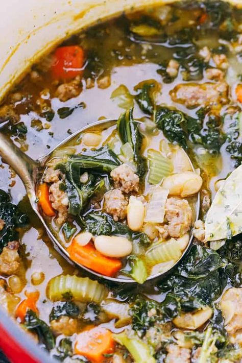 Warm up with this comforting bowl of Italian Sausage Soup, brimming with kale, beans, and flavorful spices. Kale And Beans, Kale And Bean Soup, Escarole Soup, Soup With Kale, Italian Soup Recipes, Kale Soup Recipes, Sausage And Kale Soup, Tuscan Bean Soup, Italian Sausage Soup