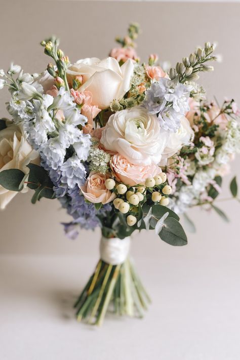 Pastel Blue and Pink Bouquet full of scent and texture. Flowers include Stocks, Delphiniums, Roses, Waxflower, & Hypericum Romantic Garden Wedding Bouquet, Pastel Flowers Bouquet, Pastel Color Bouquets, Spring Floral Bouquet Wedding, April Bridal Bouquet, Pastel Flower Bouquet Wedding, Wedding Decor Pastel Colors, Small Bridal Bouquet Spring, Pink White Blue Wedding Flowers