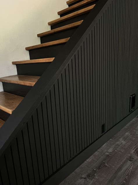 black accent wall tutorial, easy diy, diy project, slat wall, diy slat wall, pole wrap, stairway, moody decor, black wall, diy home projects, black slat wall, modern interior design, moody design, black accent wall, Black Feature Wall Staircase, Wood Slat Accent Wall Stairs, Black Wall On Staircase, Downstairs Wall Ideas, Black Walls With Accent Wall, Black Slat Wall Entryway, Basement Modern Farmhouse, Black Shiplap Stairwell, Accent Wall Around Door