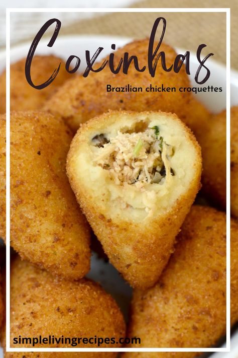 Coxinhas in a serving dish, with one opened, showing the chicken filling. Brazilian Pastries, Brazilian Coxinha Recipe, Brazilian Appetizers, Baked Chicken Croquettes, Brazilian Chicken Croquettes, Coxinha Recipe, Ramadan Snacks, Brazilian Food Traditional Aesthetic, Spanish Croquettes