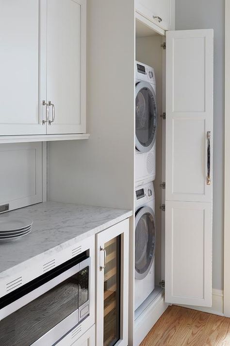 Galley style kitchen featuring hidden stacked washer and dryer in a white cabinet finished with a chrome pull. Hidden Laundry Rooms, Laundry In Kitchen, Grey Laundry Rooms, Hallway Laundry, Stacked Laundry Room, Hidden Laundry, Chicago Vintage, Galley Style Kitchen, Stackable Washer And Dryer