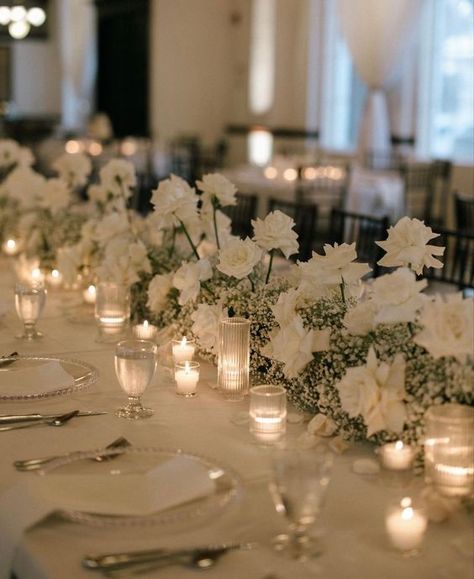 Classic White Wedding Theme, Long Table Wedding Centerpieces Candles White Flowers, White Flowers And Candles Wedding, Modern Minimalist Wedding Table Decor, Neutral Wedding Aesthetic, Wedding Theme Ideas Elegant Indoor, White Roses Centerpieces Wedding, Classy Wedding Flowers, White Flower Table Arrangements