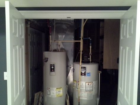 Closet for water heater and HVAC | Basements Unlimited | Basement Remodeling Columbus O Furnace Closet, Water Heater Closet, Cabin Basement, Indoor Sliding Doors, Furnace Room, Pantry Room, Basement Renovation, Basement Storage, Storage Shelving