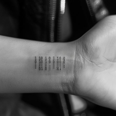 Embrace the digital age with ink! This unique wrist tattoo captures the essence of human connection through technology, translating binary codes to a warm "Hi" in ASCII. A perfect blend of geek chic and personal touch, it's a must-save and follow for anyone who appreciates the beauty in coding. Let this tattoo inspire your next piece of wearable art. #CodingArt #BinaryTattoo #GeekChic #InkInspiration #ASCII #SaveAndFollow #AIImage Binary Tattoo Ideas, Binary Code Tattoo, Programming Tattoo Ideas, Binary Tattoo, Unique Wrist Tattoos, Geometric Tattoos, Programming Code, Binary Code, Wrist Tattoo