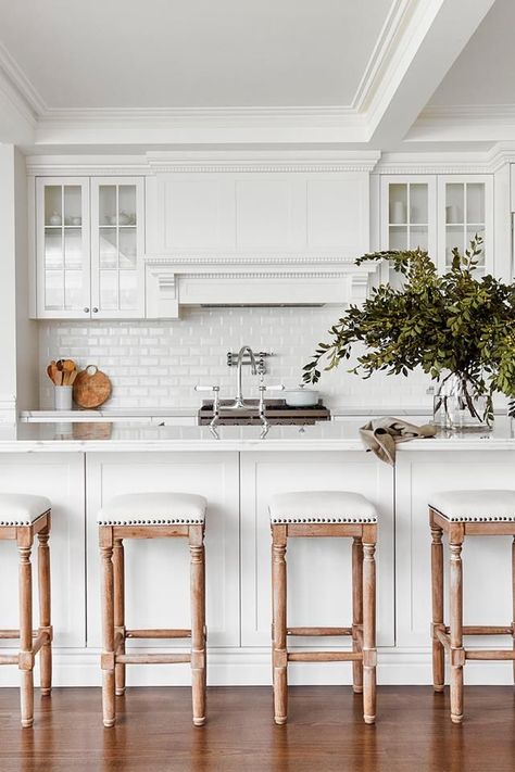 All-white Hamptons style kitchen in Polytec and finished in Dulux Lexicon Quarter. A generous kitchen island with a Statuario Venato benchtop from Smartstone with a double ogee edge. Brosa 'Clovis' bar stools and white bevel gloss subway tiles with the much-used pot filler. South American Kitchen Design, Modern Hamptons Kitchen, Hamptons Exterior, Hampton Style Kitchen, Hampton Kitchen, Hamptons Kitchen, Styl Hampton, Modern Hampton, Provincial Home