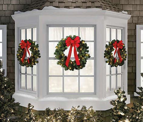 Christmas Window Wreaths That Will Make Your Home's Exterior Just as Festive as the Interior Prelit Window Wreaths, Wreaths On Front Windows, Bay Window Christmas Decor Outdoor, Wreaths On Windows Outdoor, Christmas Window Wreaths, Wreaths For Windows, Christmas Wreath On Windows Outdoor, Christmas Wreaths On Windows, Wreaths On Windows