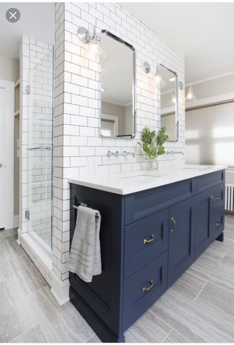 Example of a mid-sized transitional master white tile and ceramic tile porcelain floor and gray floor alcove shower design in Chicago with recessed-panel cabinets, blue cabinets, beige walls, an undermount sink, engineered quartz countertops, white countertops and a hinged shower door. By Normandy Remodeling  #bathroomremodel Navy Farmhouse Bathroom, Flooring Bathroom, Navy Blue Bathrooms, Navy Bathroom, Blue Bathroom Vanity, Blue Vanity, Transitional Bathroom, Blue Cabinets, Bath Ideas