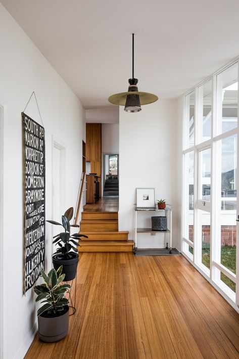 An Architect's 1958 Midcentury in Tasmania Gets a Graceful Renovation - Photo 4 of 15 - Inside the entry, which affords a view through the house towards the extension, Emery's original palette combines white walls with wood floors. Mid Century Modern Flooring, Modern Wood Floors, Mid Century Flooring, Wood Floor Design, Mid Century Wood, Modern Flooring, Mid Century Modern Wood, Mid Century Modern Bedroom, Midcentury Home