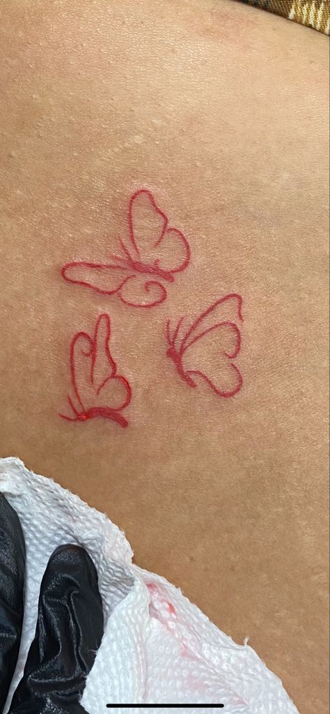 Small Red Tattoos Black Women, Red Butterfly Tattoo Shoulder, Red And Black Small Tattoo, Red Ink Tattoos Ribcage, Simple Red Butterfly Tattoo, Red Foot Tattoos For Women, Red M Tattoo, Mini Red Tattoos For Women, Red Tattoos For Black Women