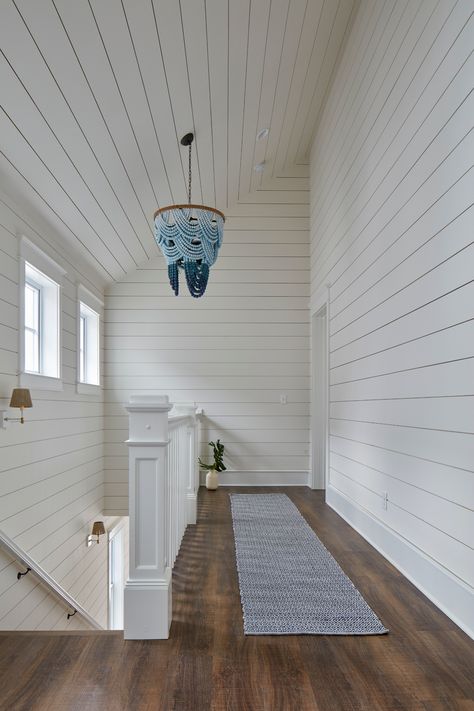 If you've followed me for a while now, you know I like to treat #staircases as their own room.⁠ ⁠ Here I added windows across the wall which acts like artwork and brightens the entire space. The high ceilings create a lot of volume that is highlighted by this amazing #OmbreWoodBeadChandelier by #ReginaAndrewDetroit. ⁠ ⁠ ⁠ #MarnieCustomHomes⁠ #BeachHappyTour⁠ #MarnieOursler #shiplap #staircase #staircasedesign #vaultedceilings #cathedralceilings #bluechandelier Coastal Staircase, Shiplap Room, Ge Cafe Appliances, Stair Nook, Bunk Bed Sets, Custom Bunk Beds, Coastal Glam, Shiplap Ceiling, Ship Lap