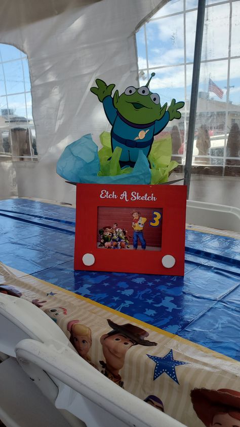 Toy Story 2nd Birthday Centerpieces, Toy Story Etch A Sketch Frame, Toy Story Table Decorations Centerpieces, Toys Story Centerpieces, Pixar Centerpieces, Toy Story Gumball Centerpiece, Toy Story Cake Table Ideas, Diy Toy Story Centerpieces, Toy Story Birthday Table Centerpieces