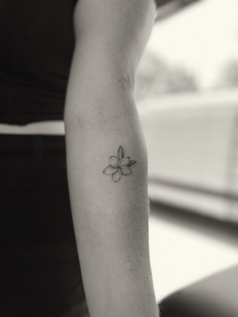 detailed flower tattoo, fine line, dainty tattoo, plumeria Small Tropical Flower Tattoos For Women, Minimalist Plumeria Tattoo, Tiny Hawaiian Flower Tattoo, Plumeria Tattoo Behind Ear, Dainty Plumeria Tattoo, White Plumeria Tattoo, Black And White Plumeria Tattoo, Fine Line Hawaiian Flower Tattoo, Fragipanni Flower Tattoo