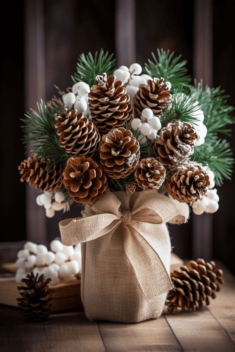 These rustic bunches look stellar with simple ceramic dishes; imagine a canvas of white, where your centerpiece paints the color. #Christmas #Holidays #HomeDecor Christmas Pine Cone Decorations, Simple Rustic Christmas Decor, Burlap Ornaments, Diy Natal, Elf Decorations, Christmas Pine Cones, Christmas Craft Ideas, Burlap Decor, Mountain Lakes