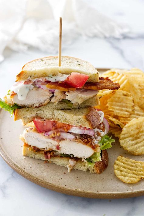 This chicken bacon ranch sandwich is a full meal deal. Crisp chicken, smoky bacon, cheese, and fresh veggies get slathered in ranch dressing. Chicken Ranch Sandwich, Ranch Sandwich, Chicken Bacon Ranch Sandwich, Crisp Chicken, Sandwhich Recipes, Best Sandwich Recipes, Creamy Ranch Dressing, Creamy Ranch, Bacon Sandwich