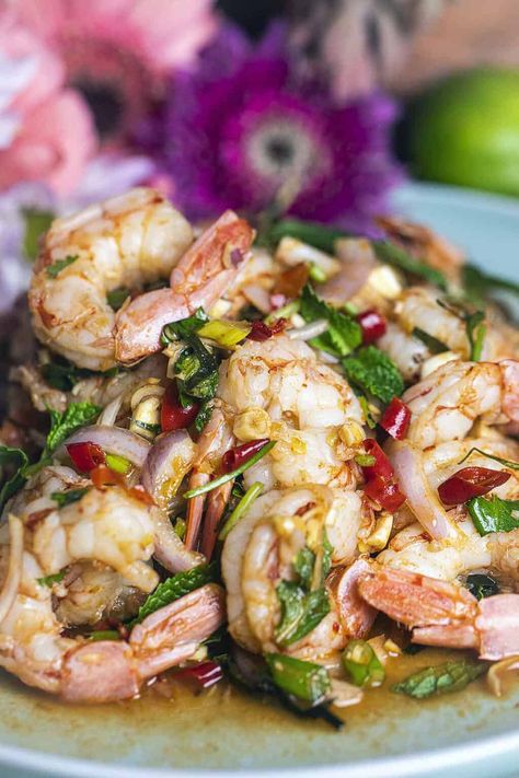 Need a tasty idea for a quick lunch? Try Pla Goong, a spicy Thai shrimp salad full of flavor. It has fresh herbs, big juicy shrimp, and spicy Thai chili peppers. The dressing is tangy and spicy too. Give your taste buds a treat with this yummy salad you'll want to eat again and again! #plagoongrecipe #plagoongingredients #plagoongsaladrecipe #thaishrimpsalad #spicythaishrimpsalad #prawnsaladthai #plagoongsalad Spicy Thai Shrimp, Chinese Salads, Thai Shrimp Salad, Thai Chili Peppers, Thai Shrimp, Prawn Salad, Thai Salads, Thai Chili, Summer Diet