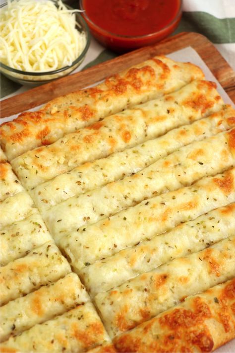 Homemade Cheese Sticks - Delicious garlic pizza crust breadsticks brushed in buttery garlic and layered with cheese. Melty, bubbly, cheesy perfection! Quick Cheesy Breadsticks, Garlic Cheese Sticks With Pizza Crust, Pizza Bread Sticks Recipe, Pizza Crust Cheese Bread, Cheesy Breadsticks Pillsbury, Cheesy Pizza Sticks, Garlic Cheese Pizza Bread, Cheesy Bread Sticks Recipe, Homemade Garlic Cheese Breadsticks