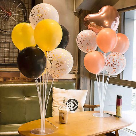 Two balloon stand kits with seven balloons each in different colors on a table in a coffee shop. Balloons On Sticks, Simple Balloon Decoration, Stick Centerpieces, Balloon Table Centerpieces, Balloon Stand, Balloon Holders, Balloons Decoration, Birthday Party Accessories, Diy Table Top