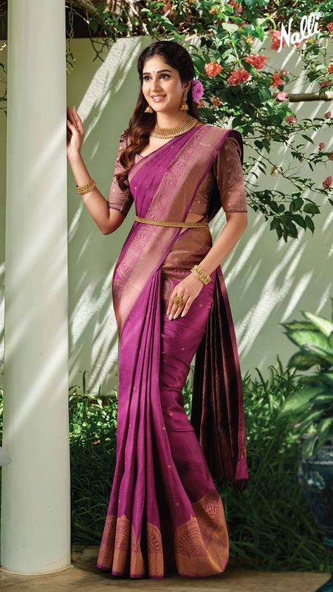 This maroon Kanchipuram silk saree is crafted in zari butta designs all over the body, with an elaborate zari-patterned border and pallu. Pair this saree with a gold choker, jhumkas, and a belt to achieve the traditional look. Indian Engagement Saree, Purple Kanchipuram Saree, Pastel Sarees, South Indian Wedding Saree, South Indian Bride Saree, Engagement Saree, Saree With Belt, Lehenga Saree Design, Bridal Sarees South Indian