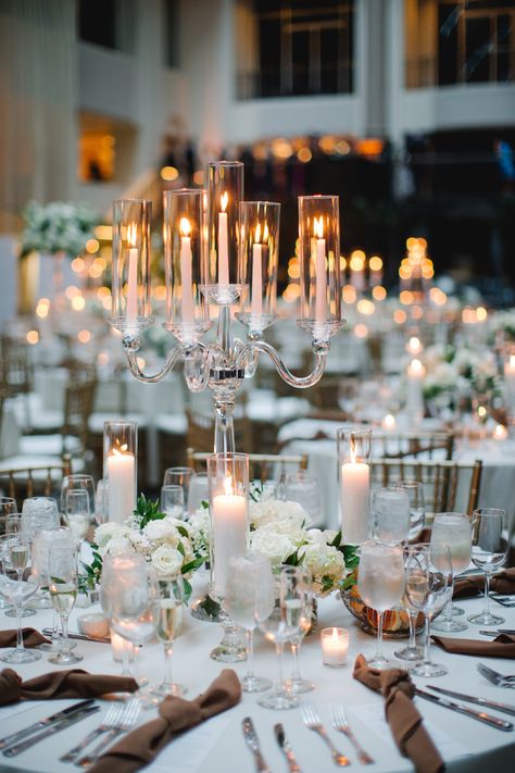 Classic arm crystal candelabra centerpiece with petite arrangements surrounding the base and more candlelight. PC: Asya Photography https://asyaphotography.com/ Chandelier Table Centerpiece, Large Candle Centerpieces Wedding, Candle Bar At Wedding, Candelabras Centerpieces, Candles As Centerpieces, Big Centerpieces, Chandelier Centerpiece Wedding, Candle Lit Wedding Tables, Candelabra Centerpieces