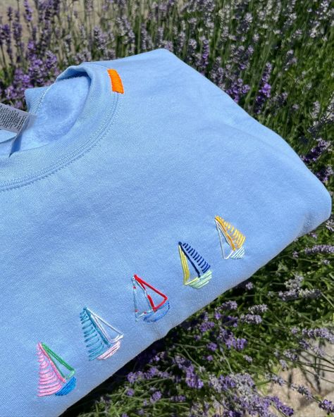 newest edition: sailboats! a fun custom piece for a special someone @haydenbrennen ⛵️🤭🩵🐚🐟🐠 #stitchiesbyag #toronto #custom #handstitched #fyp #pinterest #uniquesweatshirts #customclothing #customdesign #design #clothing #sweatshirt #crewneck #summer #ocean #microinfluencer Patchwork Crewneck Ideas, Homemade Shirts Ideas Diy, Freehand Embroidery Ideas, Embording Design, Embording Ideas, Things To Embroider, Stitched Clothes, Sailboat Embroidery, Seashells Embroidery Designs