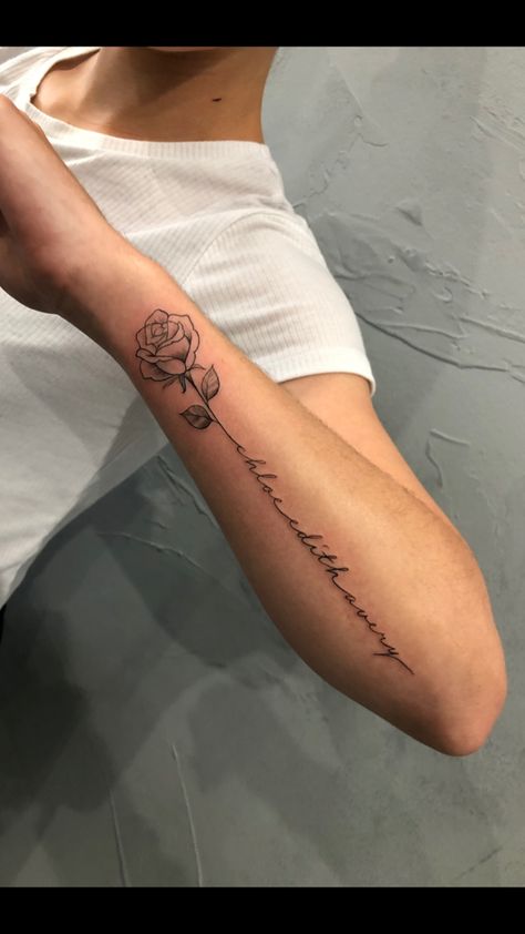 Quote With Rose Tattoo, Rose Four Arm Tattoo, Rose Quote Tattoo Forearm, Long Stem Rose Tattoo Forearm, Tattoos For Women Roses Arm, Rose Words Tattoo, Rose With Writing Stem Tattoo, Rose Into Word Tattoo, Writing Tattoos With Flowers