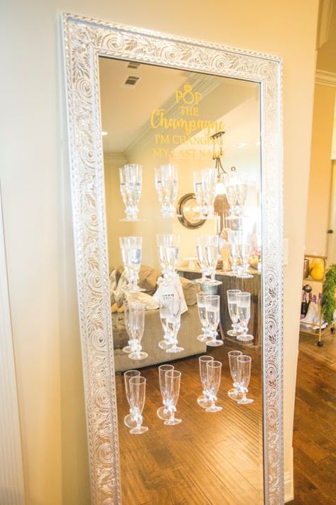 mirror champagne wall #champagnewall #diy #champagne #bridalshower #weddings #popthechampagneimchangingmylastname Mirror Champagne Wall, Party Favors Wall, Champagne Wall Decorations, Small Champagne Wall, Champagne Bottle Display, Champagne Mirror Wall, Bachelorette Mirror Decor, Diy Champagne Wall Easy, Champagne Wall Diy