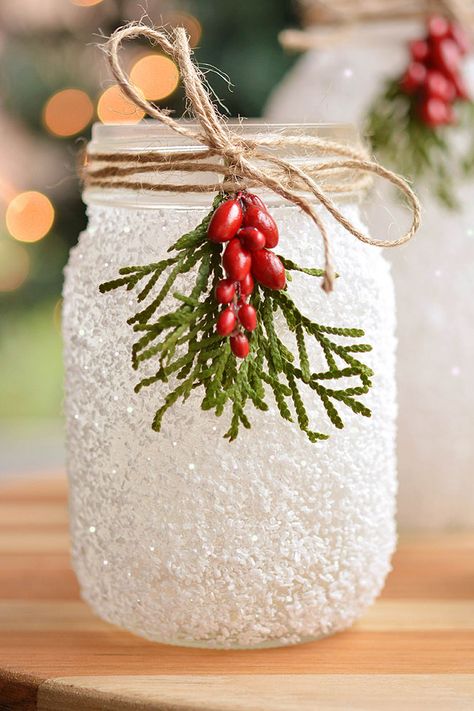 These DIY snowy mason jars made with glitter and epsom salt are SO PRETTY and they're really easy to make! A perfect Christmas craft that you can display all winter long. These mason jar luminaries are a great holiday project - and they only take 15 minutes to make! Snowflake Mason Jars, Stain Mason Jars Diy Glass Paint, Snowman Luminary Jar, Mason Jar Glitter Diy, Mason Jar Repurpose, Ball Jars Ideas Diy Projects, Epsom Salt Christmas Decor, Glass Jar Crafts Christmas Diy Projects, Snow Mason Jars