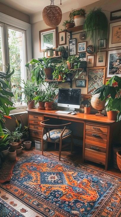 An inviting home office space featuring a wooden desk, vibrant plants, and eclectic wall art. Eclectic Maximalism Desk, Home Office Ideas Eclectic, Wooden Working Desk, Desk Facing Into Room, Garden Theme Office, Eclectic Office Decor Workspaces, Eclectic Maximalism Office, Small Cozy Office Ideas, Witchy Home Office