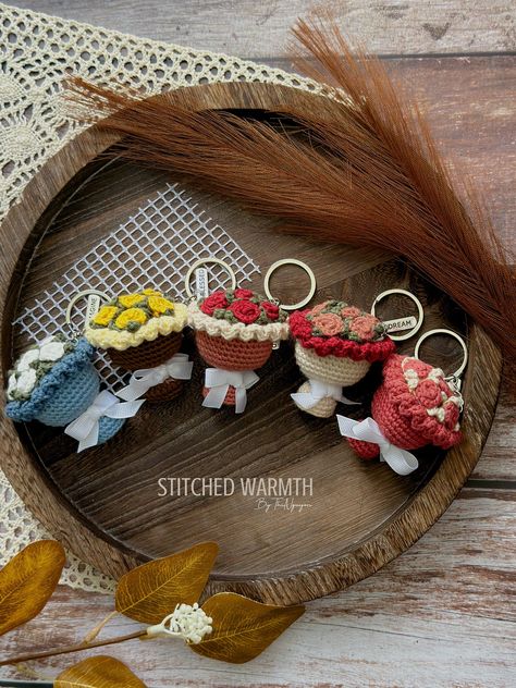 This crocheted flower bouquet keychain is the perfect way to add a touch of springtime joy to your keys. With its bright colors and cheerful blooms, it's sure to put a smile on your face every time you see.#crochetkeychain #handmadegifts #DIYkeychain #crochetlove #keychainaddict Croche Keychains, Crochet Flower Bouquet Keychain, Cute Crochet Charms, Crochet Keychain Ideas Gifts, Bag Charms Crochet, Crochet Gift Ideas For Friends, Crocheted Flower Bouquet, Crochet Cute Keychain, Flower Crochet Keychain