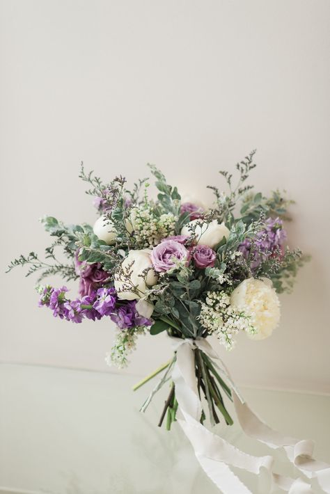 A gorgeous, organic, garden-inspired bouquet featuring lavender stock, lavender spray roses, lavender limonium, white peony, white lilac, and pearl acacia. Photo: Allie Siarto + Co. Photography #weddingbouquet #bridalbouquet #eastlansingbride #eastlansingwedding #lavenderbouquet #purplebouquet #whitepeony #whitepeonybouquet #peonybouquet #bouquettails #bouquetribbon #lavenderflowers #lavenderfloral #lavenderandwhite #lavenderwedding #greenerywedding #greenerybouquet #gardenbouquet Lavender Wedding Bouquet, Lavender Wedding Theme, Greenery Bouquet, Purple Wedding Bouquets, Lavender Bouquet, Purple Bouquet, Lilac Wedding, Floral Event Design, Peonies Bouquet