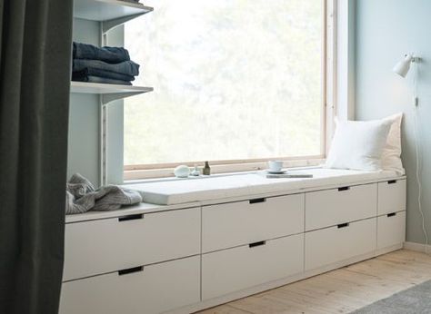 A wall with a window and a row of low bedroom storage made from modern, white chests of drawers Nordli Ikea, Ikea Hack Living Room, Bedroom Window Seat, Diy Mattress, Ikea Nordli, Bedroom Storage Chest, Soothing Bedroom, Design Ložnic, Peaceful Bedroom