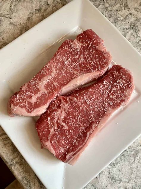 Salt seasoned strip steaks Strip Steaks On The Grill, Kc Strip Steak Recipe Oven Baked, Kc Strip Steak Recipe, Strip Steak Recipe Oven, Pan Fry Steak, Strip Steaks, Salt Brine, Strip Steak Recipe, Cook Steak