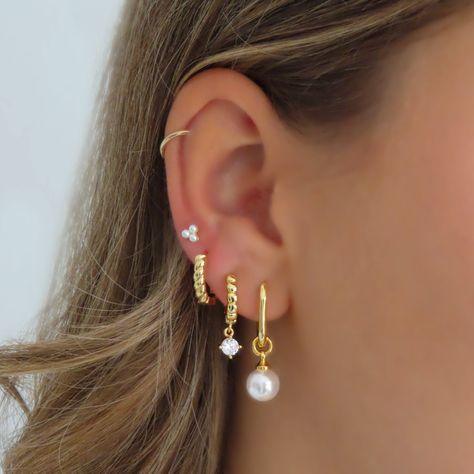 Add a touch of elegance with these triple pearl dot studs. These earrings offer a classic look with a modern twist, perfect for any occasion. Upgrade your jewelry collection with Pearlio Earrings. Many Earrings, Earring Stack Ideas 3 Holes, Stacker Earrings, Earring Stack 3, Earing Inspo Aesthetic, Gold Droplet Earrings, Ear Party Piercings, Triple Piercing Stack, Three Stack Earrings