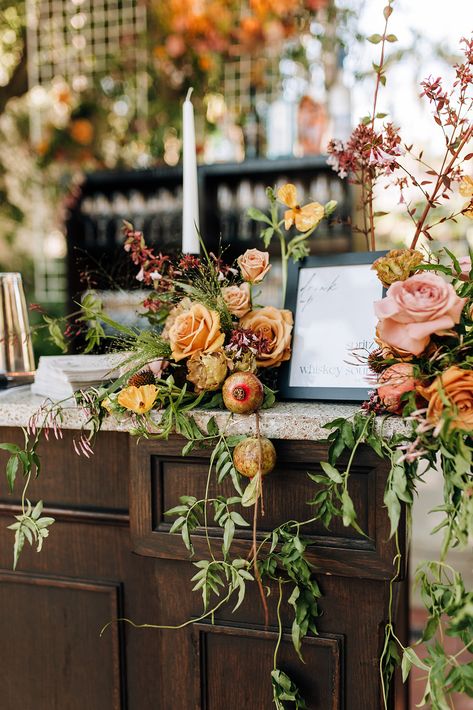 Dressed up bar menu encapsulated in an organic display of florals. Whimsical Greenery Wedding, Italian Inspired Floral Arrangements, Wedding Bar Flower Arrangement, Fall Floral Table Arrangements, L Shaped Flower Arrangement, Bar Floral Arrangement Wedding, Fall Florals Wedding, Bar Flowers Wedding, Bar Arrangement Wedding