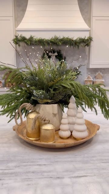 Ashley Savage | Creator | Atlanta, GA on Instagram: "🎄Christmas Kitchen Centerpiece🎄comment SHOP to get everything sent to your inbox! I know it is early, but these stems always sell out every year and they are currently on MAJOR sale, so I wanted to share!! I have been using these greenery stems for a couple years now and they are still my favorite! The light up branches are a fun touch and look beautiful at night. This Christmas centerpiece idea that would be so cute on your kitchen island for the holiday season! • • • #ltkholiday #ltkhome #christmasdecor #christmastree #christmascenterpiece #christmasideas #christmasdiy #christmasdecorating #christmastable #christmasgreenery #kitchencenterpiece #kitchenisland #kitchendecor #coffeetabledecor" Christmas Pitcher Decor, Christmas Stool Decorations, Winter Island Centerpiece, Bowl Of Ornaments Centerpieces, Christmas Kitchen Shelves Decor, Christmas Doughbowl Centerpiece, Holiday Countertop Decor, Christmas Trees On Tables, Christmas Decor For Kitchen Island Table Centerpieces