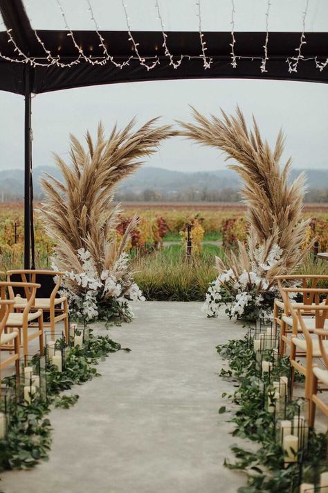 Looking down the aisle at the pampas grass wedding arch with the vineyard in the background. Wedding Ideas Pampas, Wedding Aisle Boho, Wedding Decorations Pampas, Pampa Wedding Decor, Pampas Grass Arch, Pampas Decoration, Pampas Wedding Arch, Pampas Decor Wedding, Pampas Decor