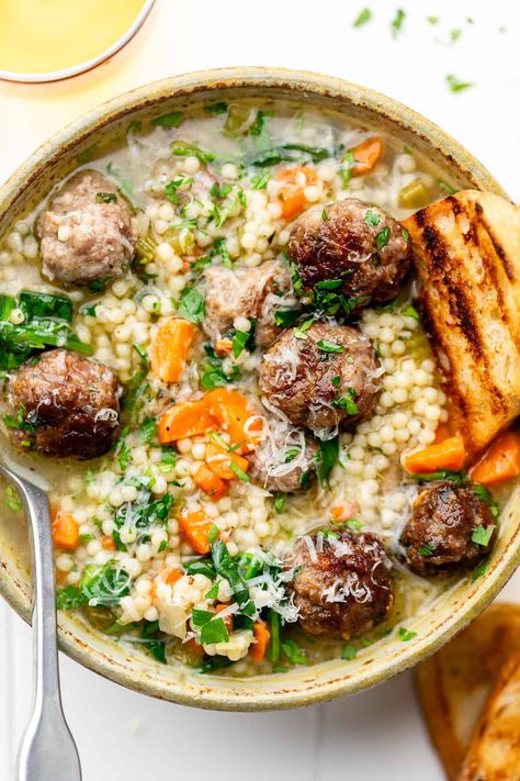 Load up on protein, complex carbs, and nutritious vegetables with this Italian Wedding Soup Recipe. From the meatballs to the pasta, it's got it all. The dish serves 12! Erin Lives Whole Italian Wedding Soup, Italian Wedding Soup Ina Garten, Italian Wedding Soup Healthy, Wedding Soup Italian, Healthy Italian Wedding Soup, Wedding Soup Recipe, Erin Lives Whole, Healthy Italian Recipes, Italian Wedding Soup Recipe