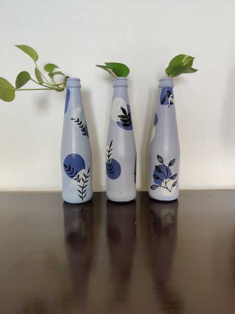 A set of three hand-painted bottles perfect for gifting and home decor Boho Bottle Painting, Boho Art On Bottle, Bottle Hanging Decor, Aesthetic Bottle Painting, Aesthetic Bottle, Bottle Paintings, Bottle Designs, Painted Bottles, Easy Room Decor