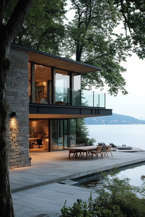 Lakeside house indoor outdoor living. Discover sleek and stylish concepts for modern lakeside homes that fuse natural beauty with contemporary living. Modern Waterfront Homes, House With Nice View, Beach Homes Exterior Seaside Coastal, Glass Lake House, Modern Glass House Exterior, Lake House Modern, Contemporary Lake House, Modern Cabin House, Lakeside House